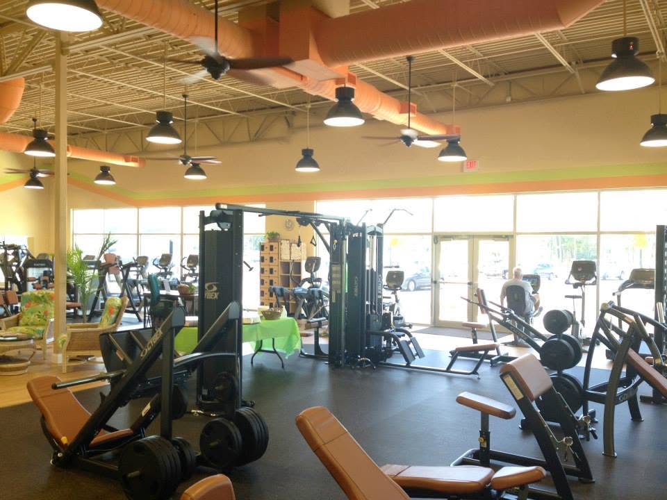 The main floor at Edison's Smart Fitness — rows of Cybex treadmills and selectorized strength machines under daylight from the storefront windows.